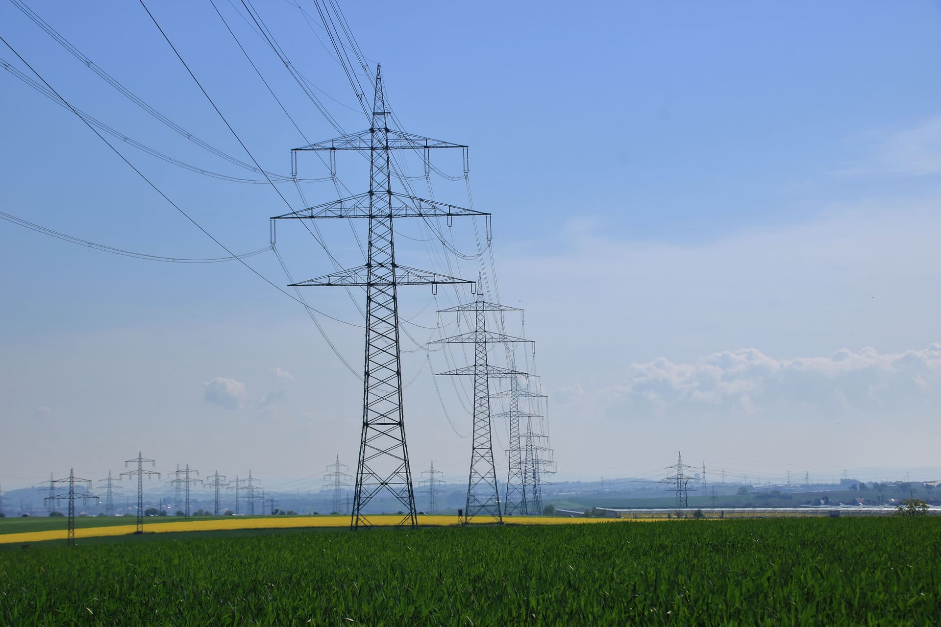 power lines over a green field