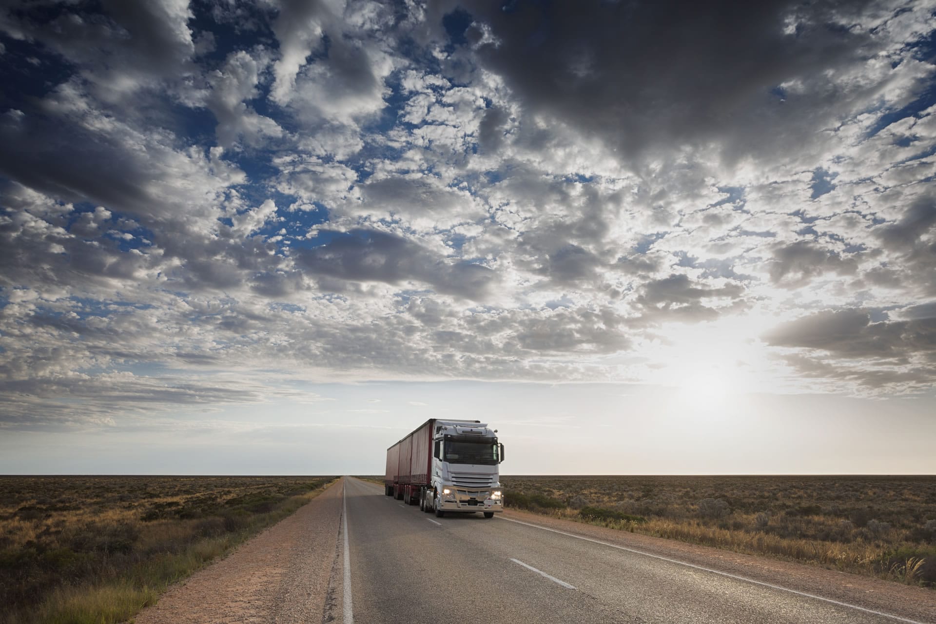 Truck on outback road under big sky