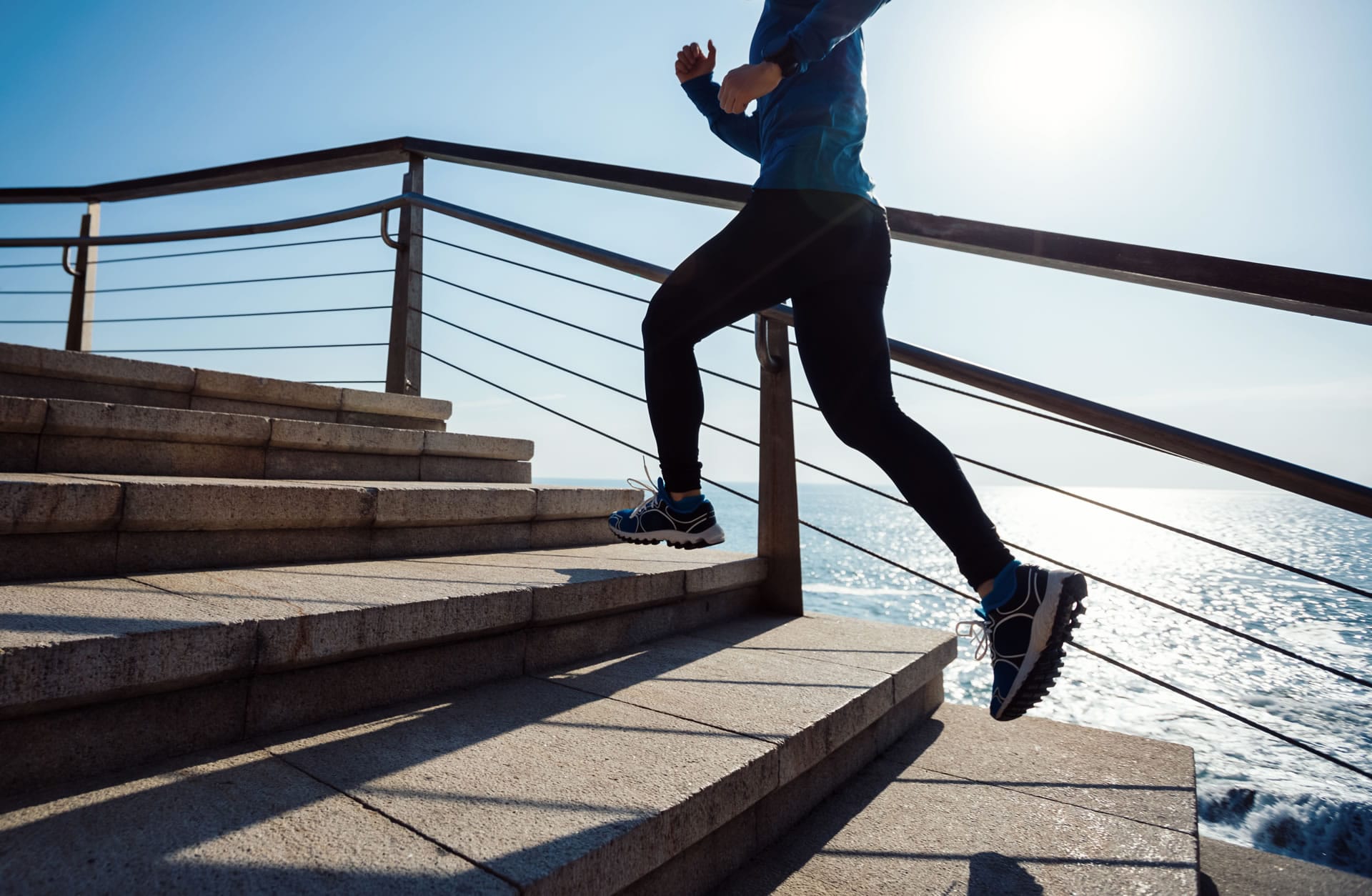Runner on stairs by sea