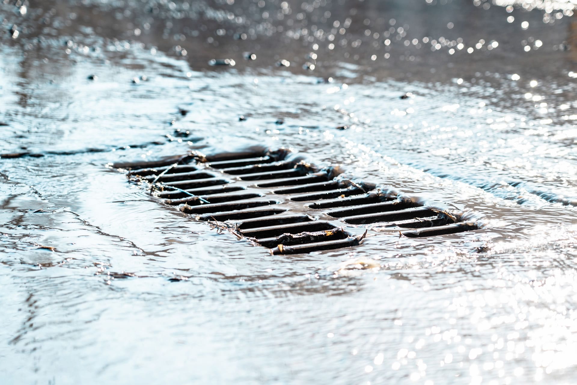 Water flowing into street drain