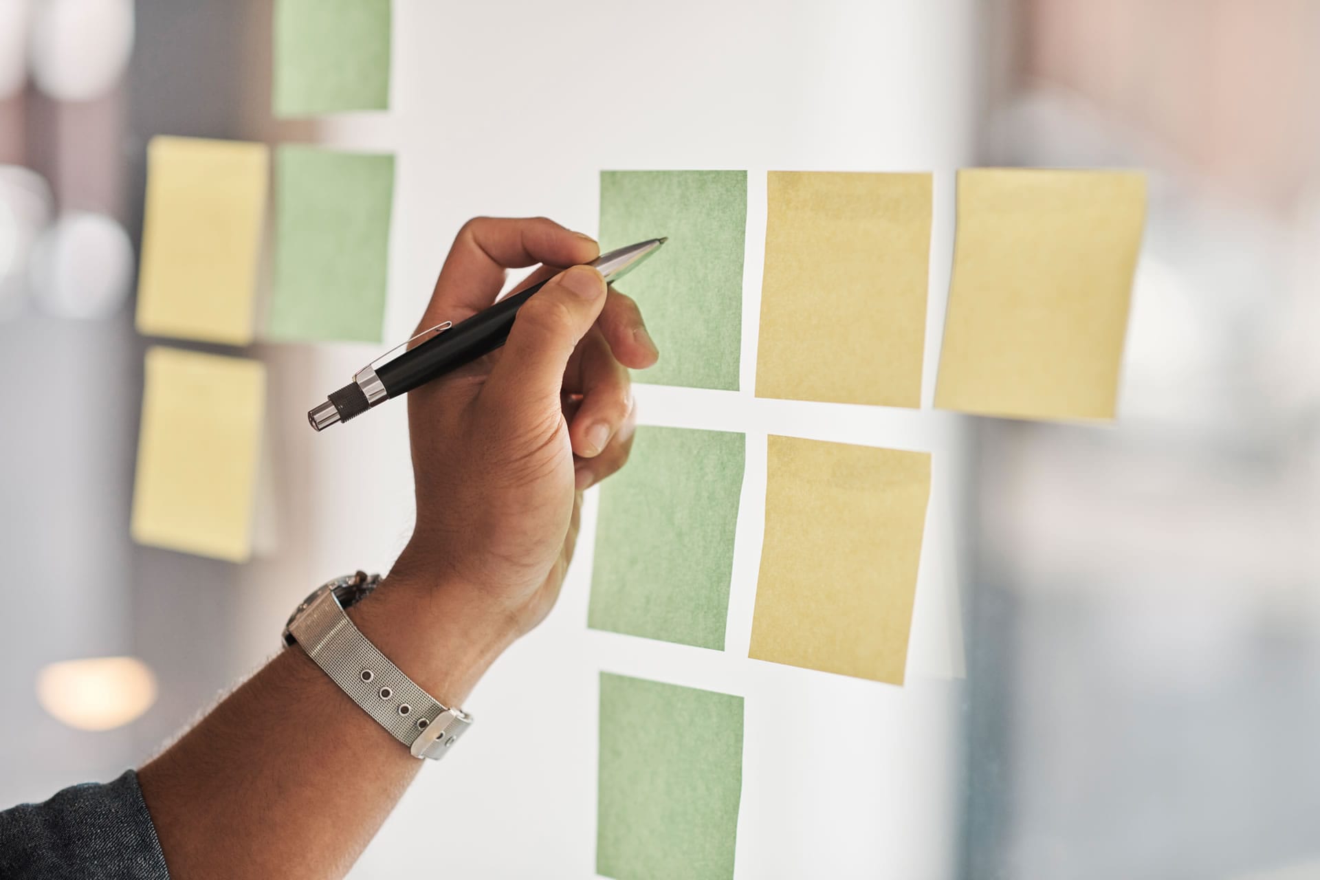 Hand placing sticky notes