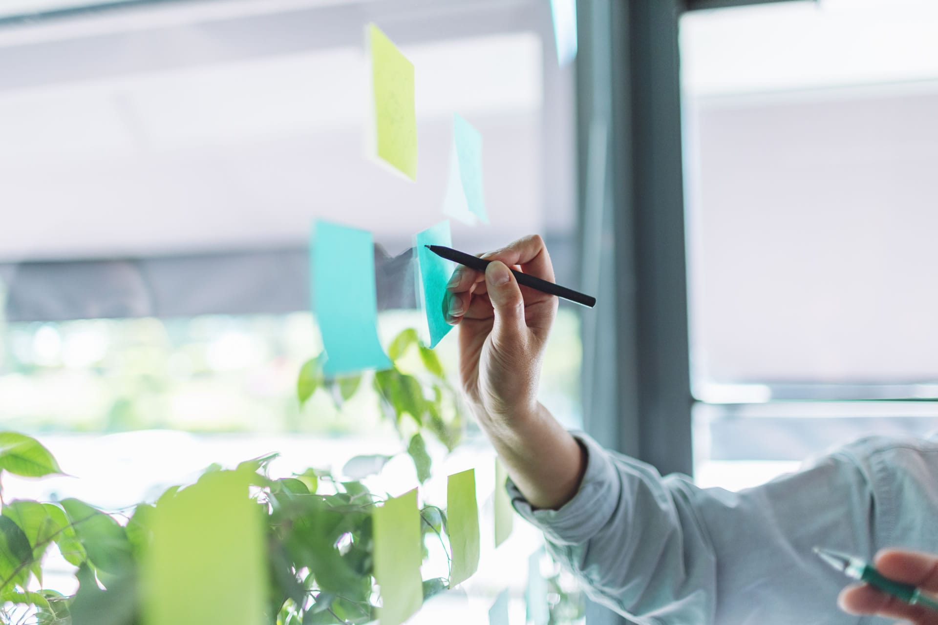 Hand writing on glass with sticky notes